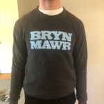 dark heather gray crew neck with light blue lettering